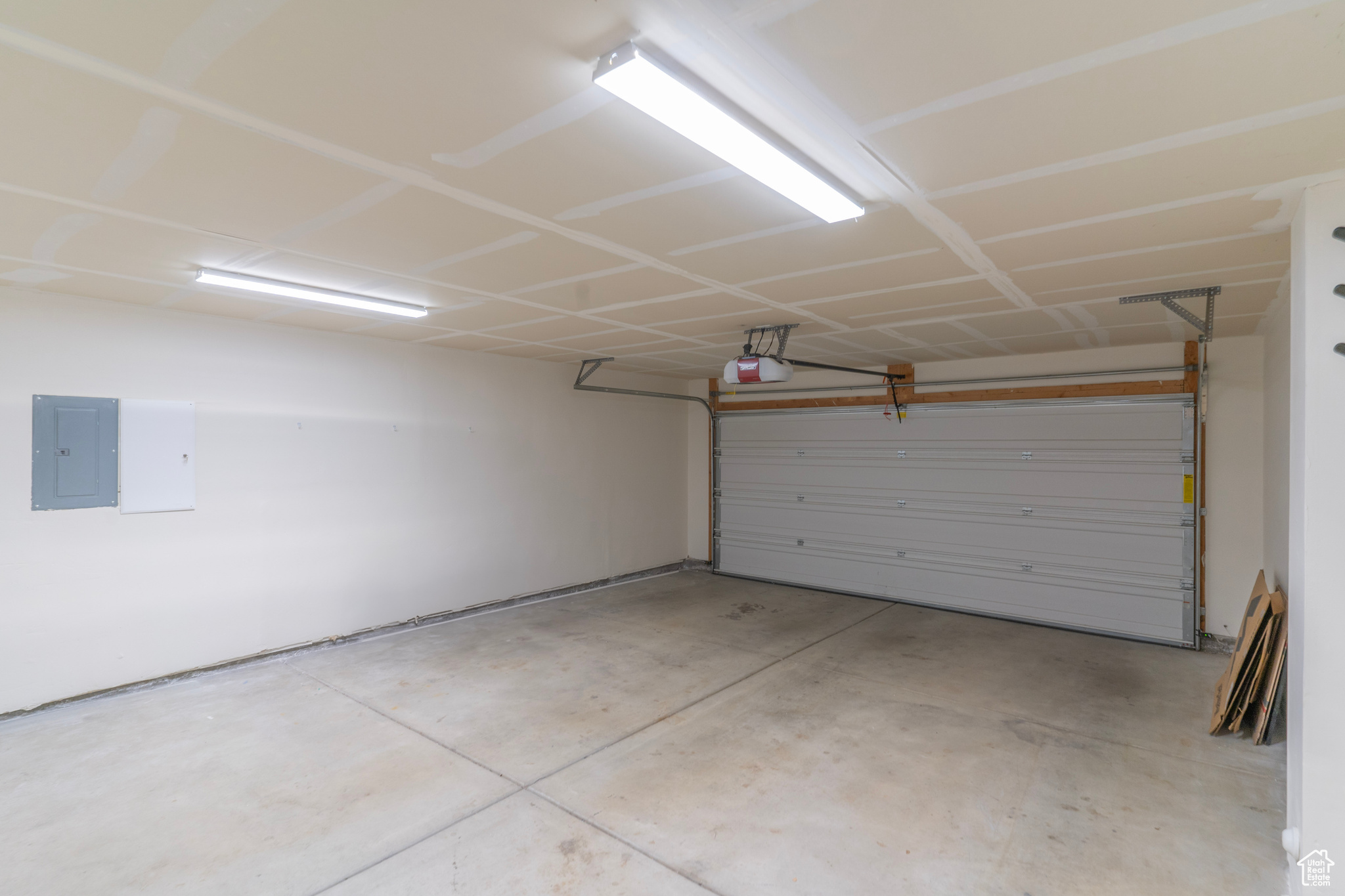 The 2 car attached garage with storage room opens to a shared drive off the street.