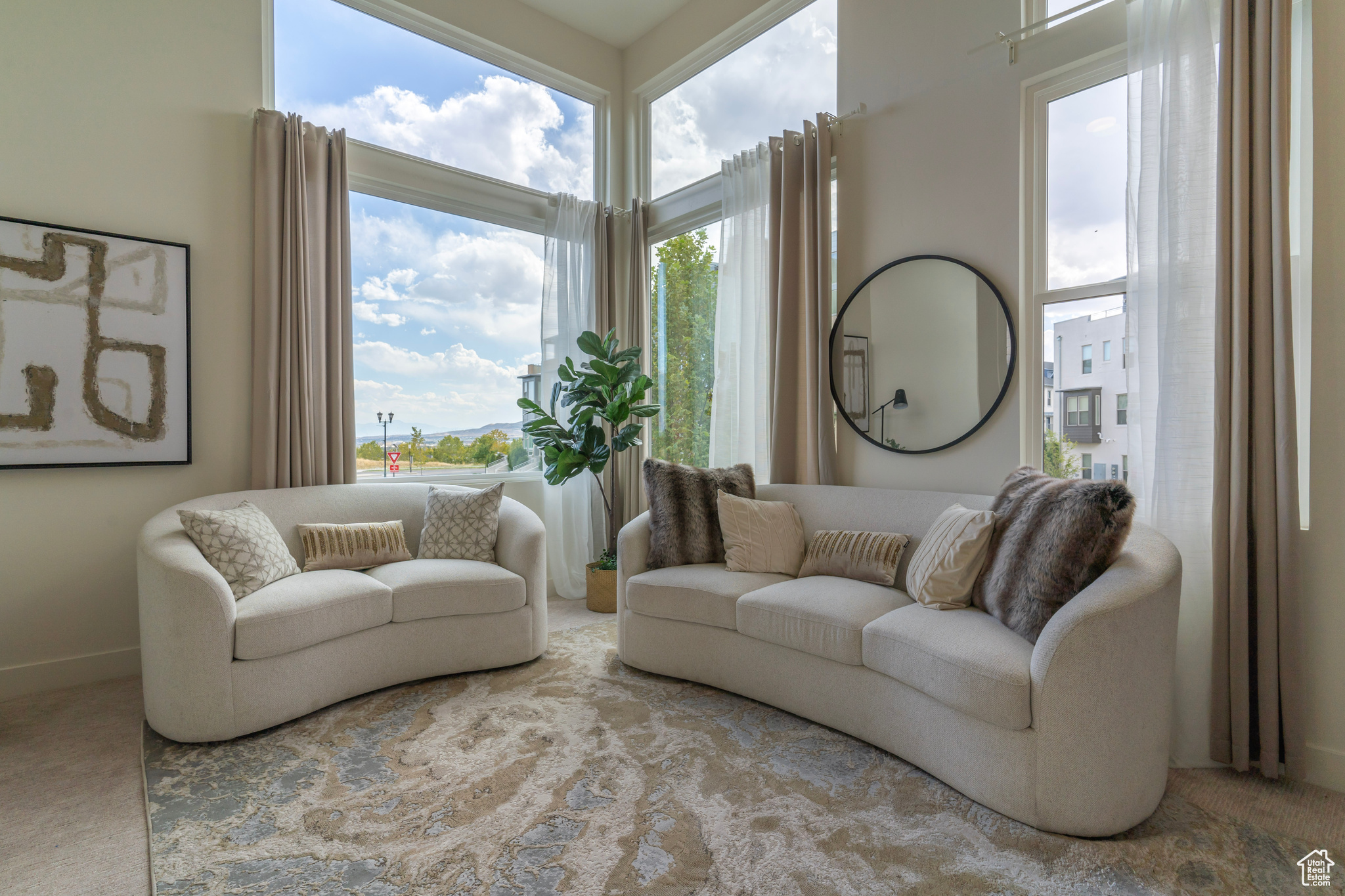 Elevated from the street, the serene living room floats above the bustle and features the expansive sky and mountains. What a welcome reception after a long day!