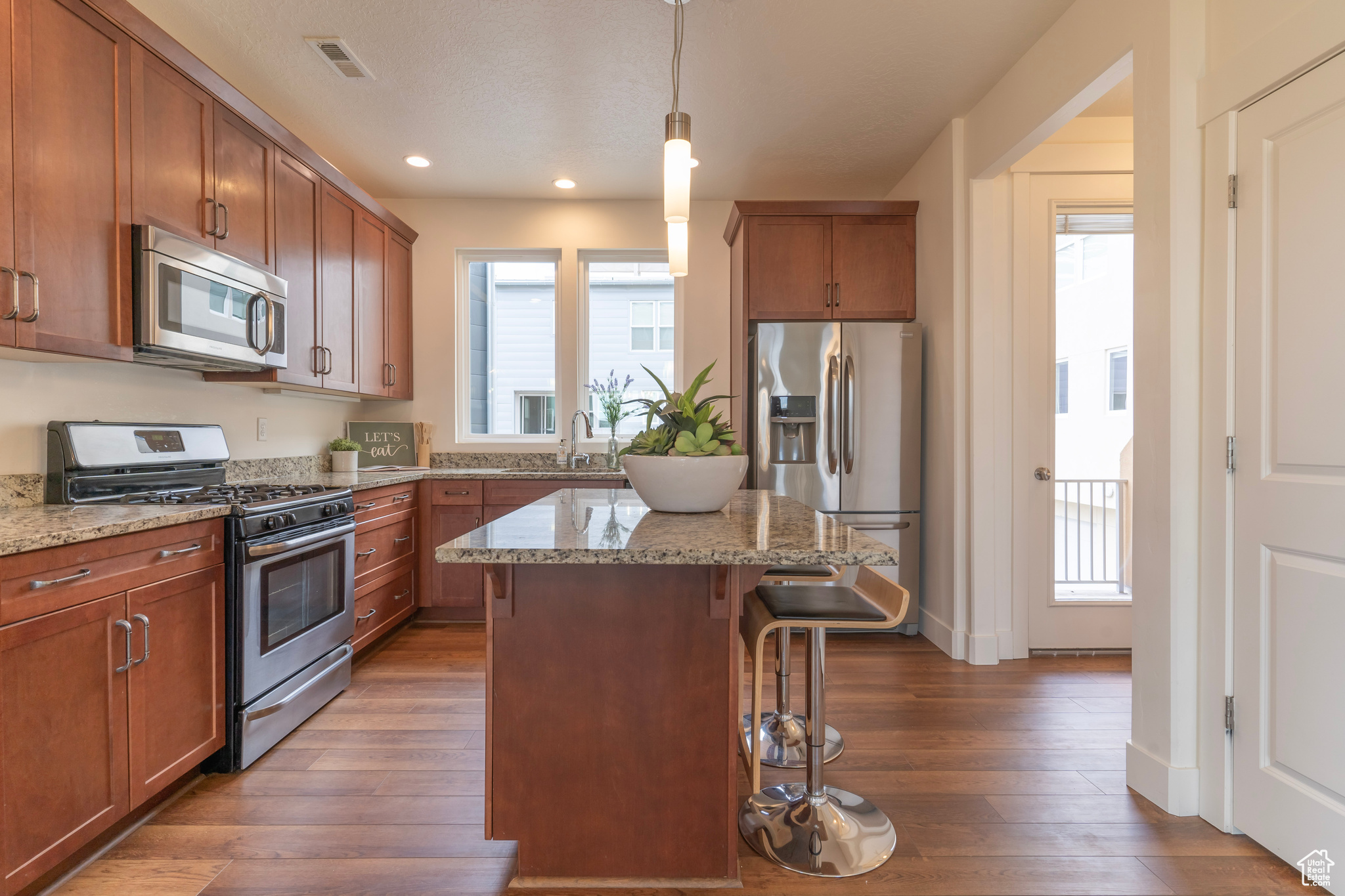 Entertain any sized group with this open concept kitchen featuring natural light, a centralized island with room for seating, gas stove, refrigerator and a balcony perfect for grilling. Then tucked just beyond the kitchen is a convenient and discreet powd