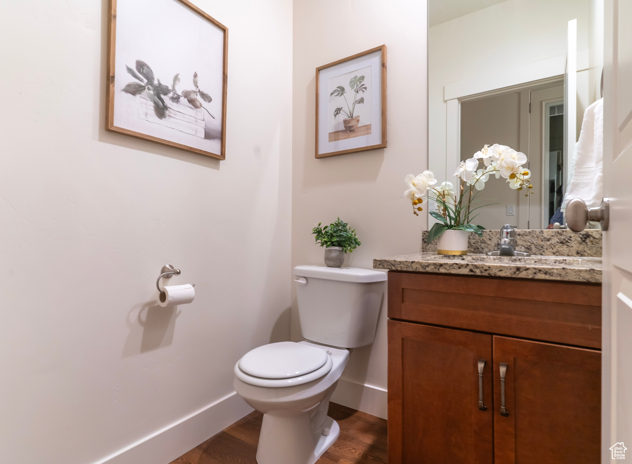 This half bath is tucked out of sight just steps from the main gathering areas to add convenience and privacy.