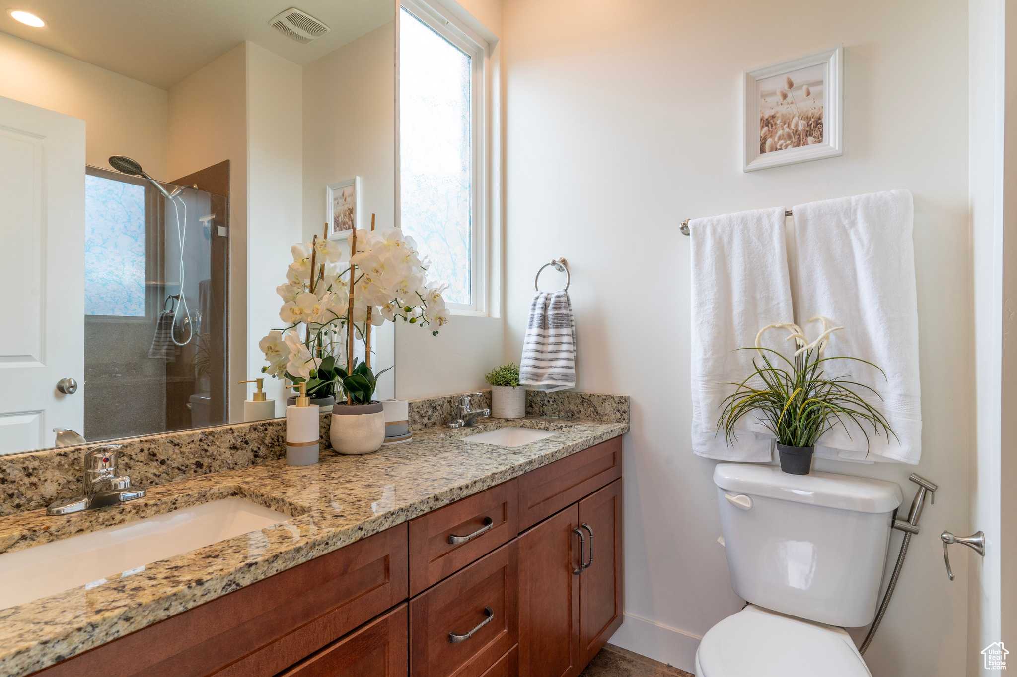 The private primary bathroom features 2 sinks, granite countertops and a generous sized shower.