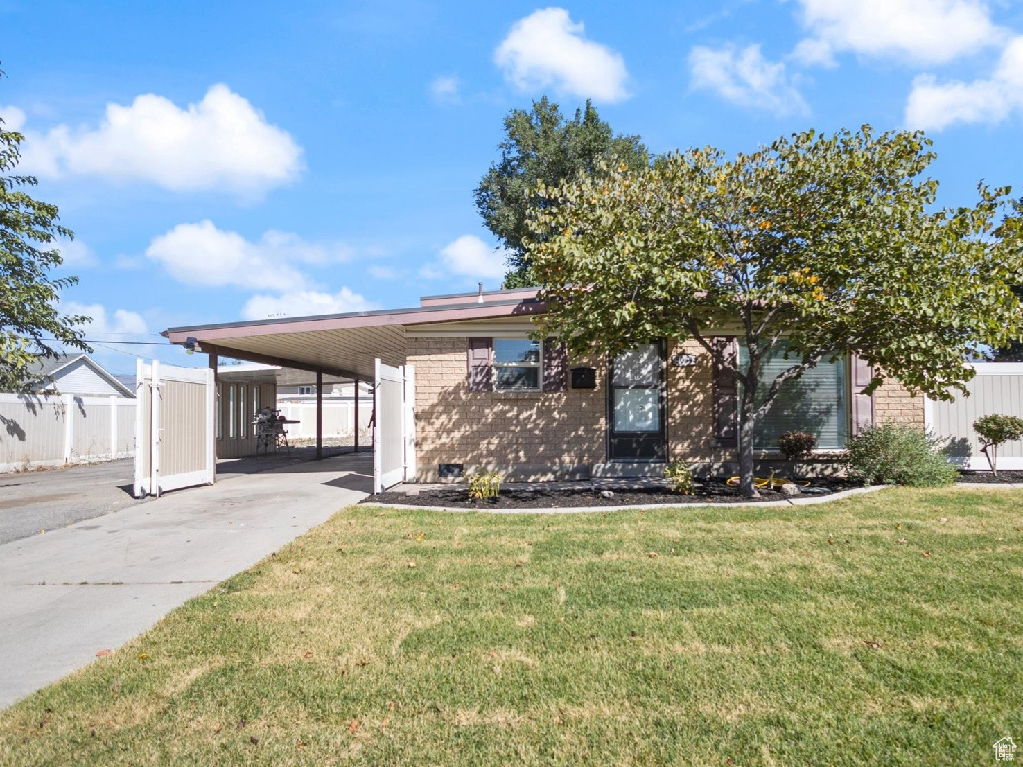 View of front of home with a front lawn and a carport