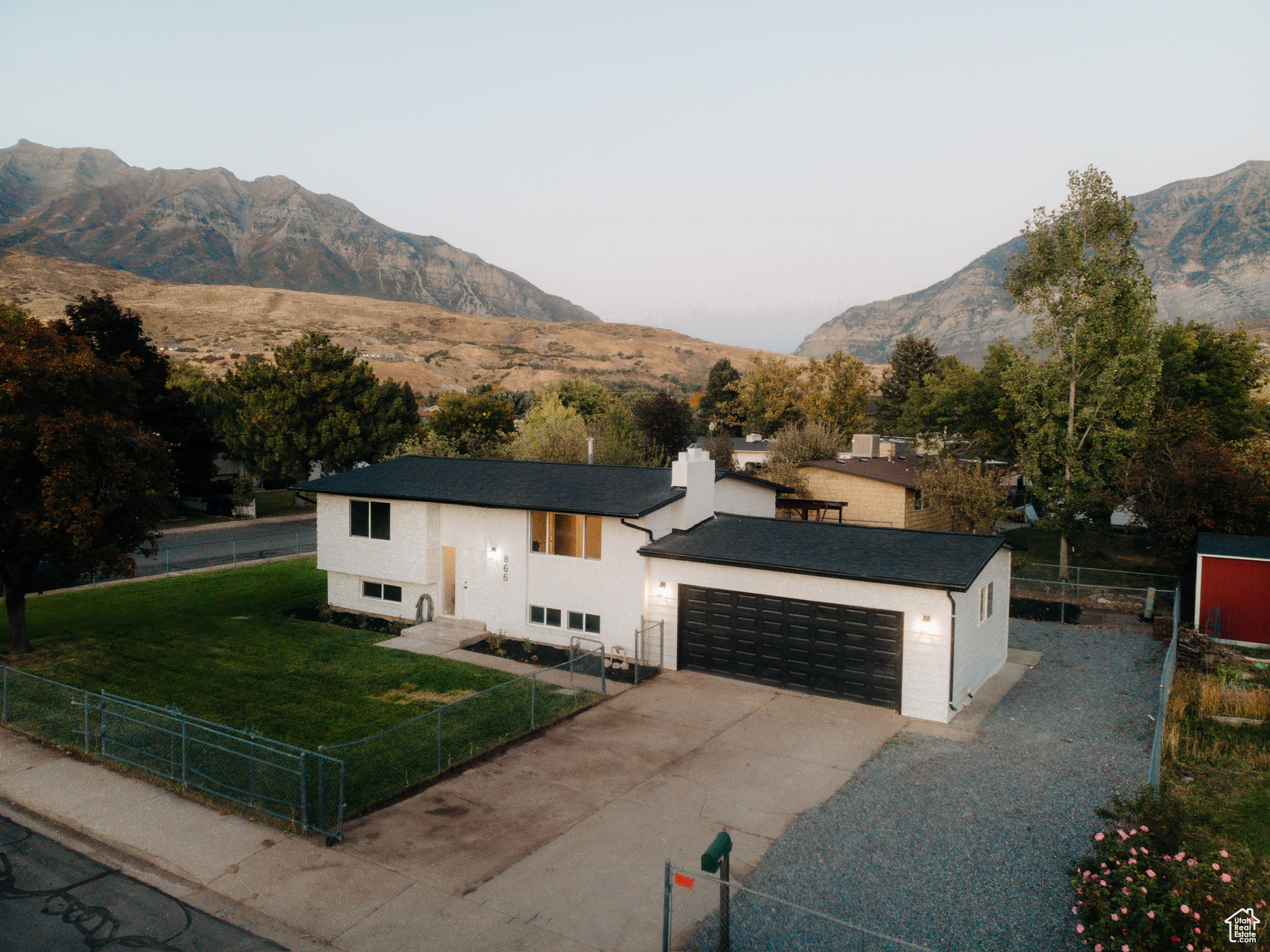 View of front of home with a front yard and a mountain view