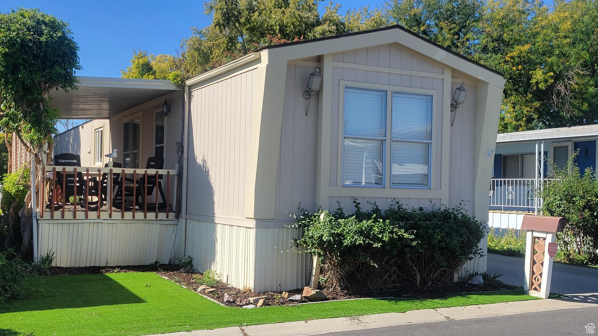 View of property exterior with a lawn