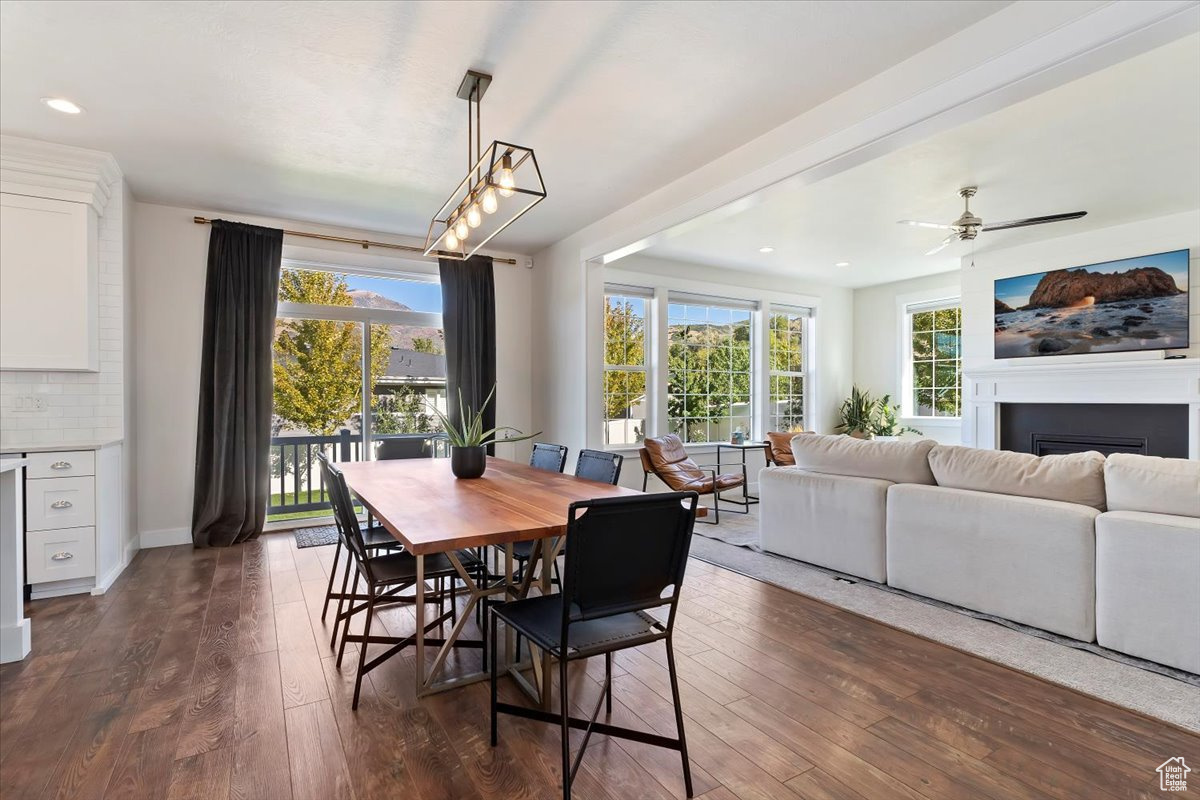 Dining space with ceiling fan, dark hardwood / wood-style floors, and plenty of natural light