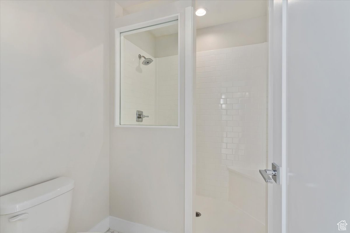 Bathroom with a tile shower and toilet