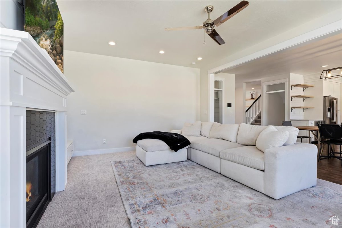 Living room featuring ceiling fan and light colored carpet