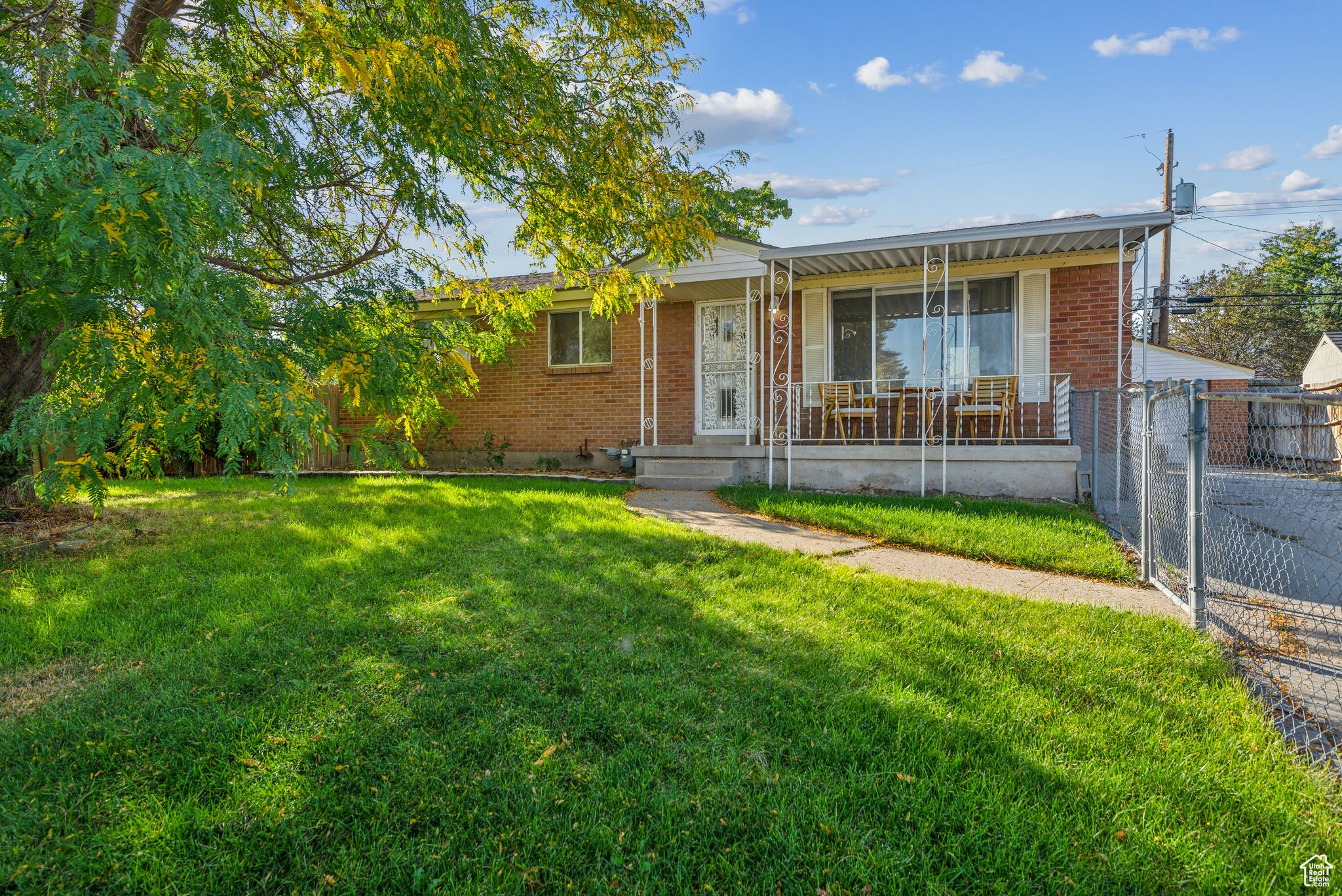 View of front of property with covered porch and a front yard