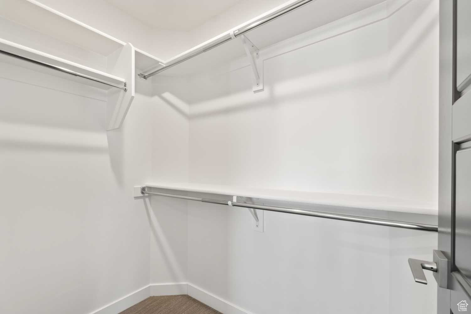 The primary bedroom features a walk-in closet with long and short hanging options