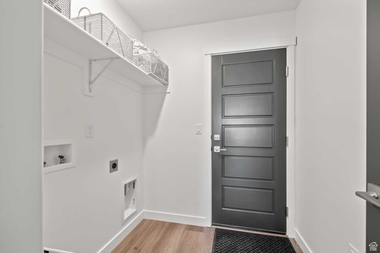 Off the garage, the laundry room includes electric dryer hookups and a shelf perfect for storing detergents and more