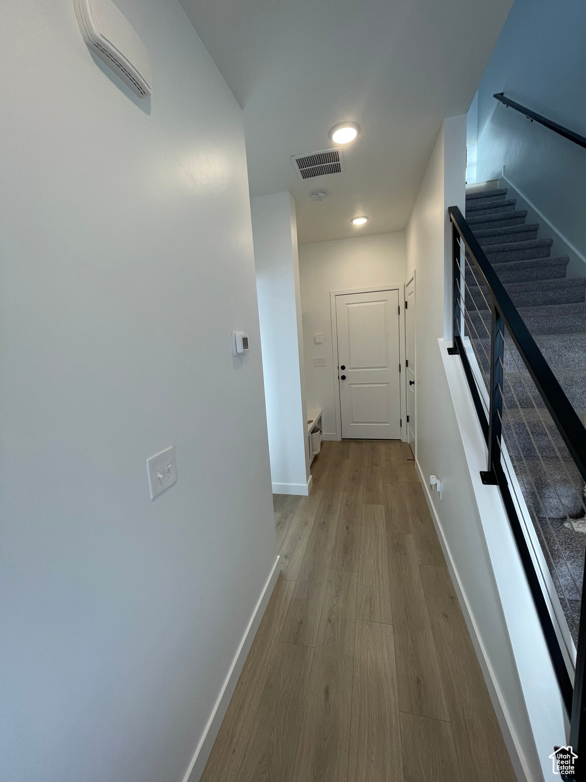 Hall with light hardwood / wood-style flooring