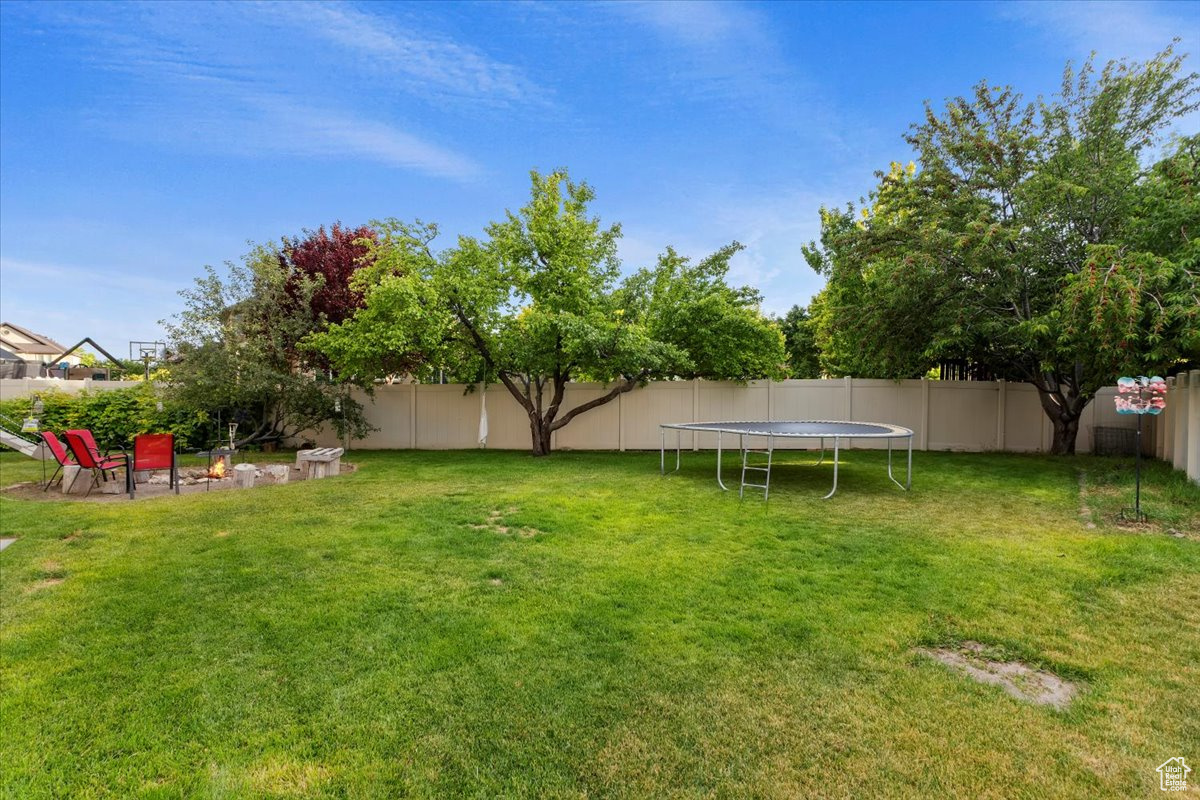 View of yard with a trampoline