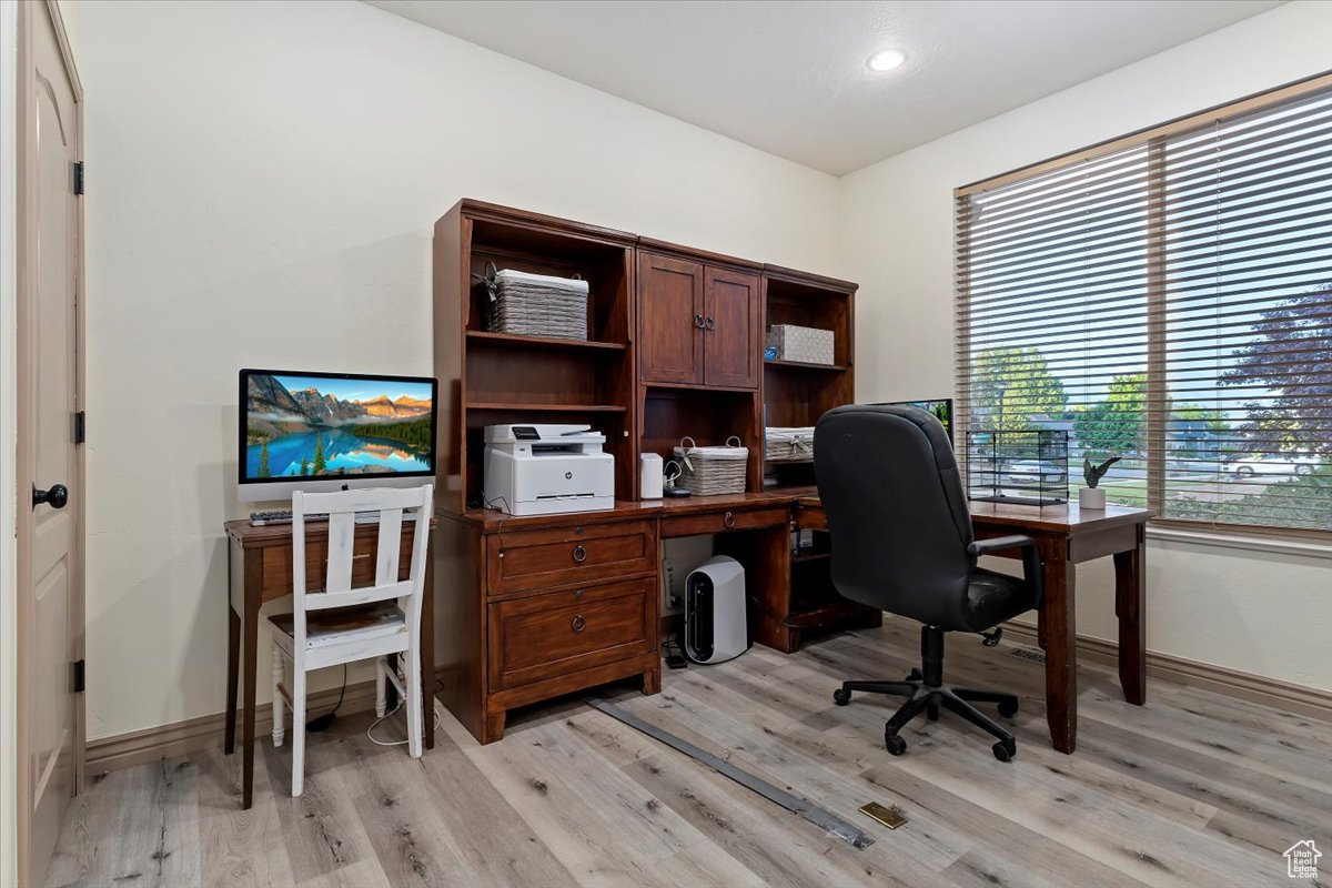 Office area with light wood-type flooring