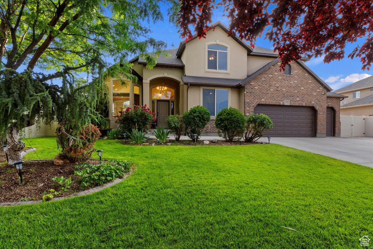 View of front facade with a front yard and a garage