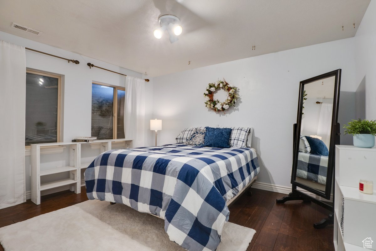 Bedroom with dark wood-type flooring