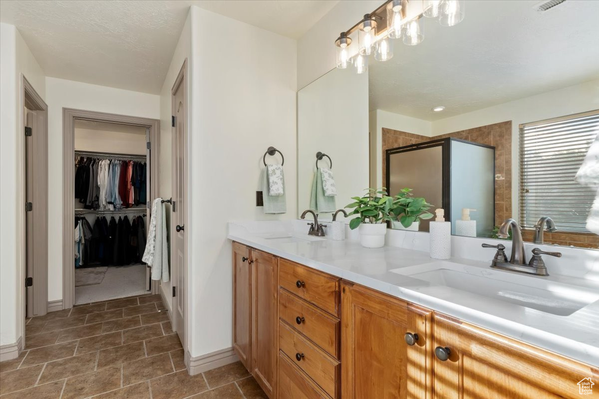 Bathroom with double vanities featuring walk in shower and soaker/garden tub