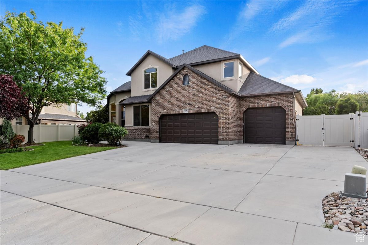 View of front of home with a front lawn and a garage