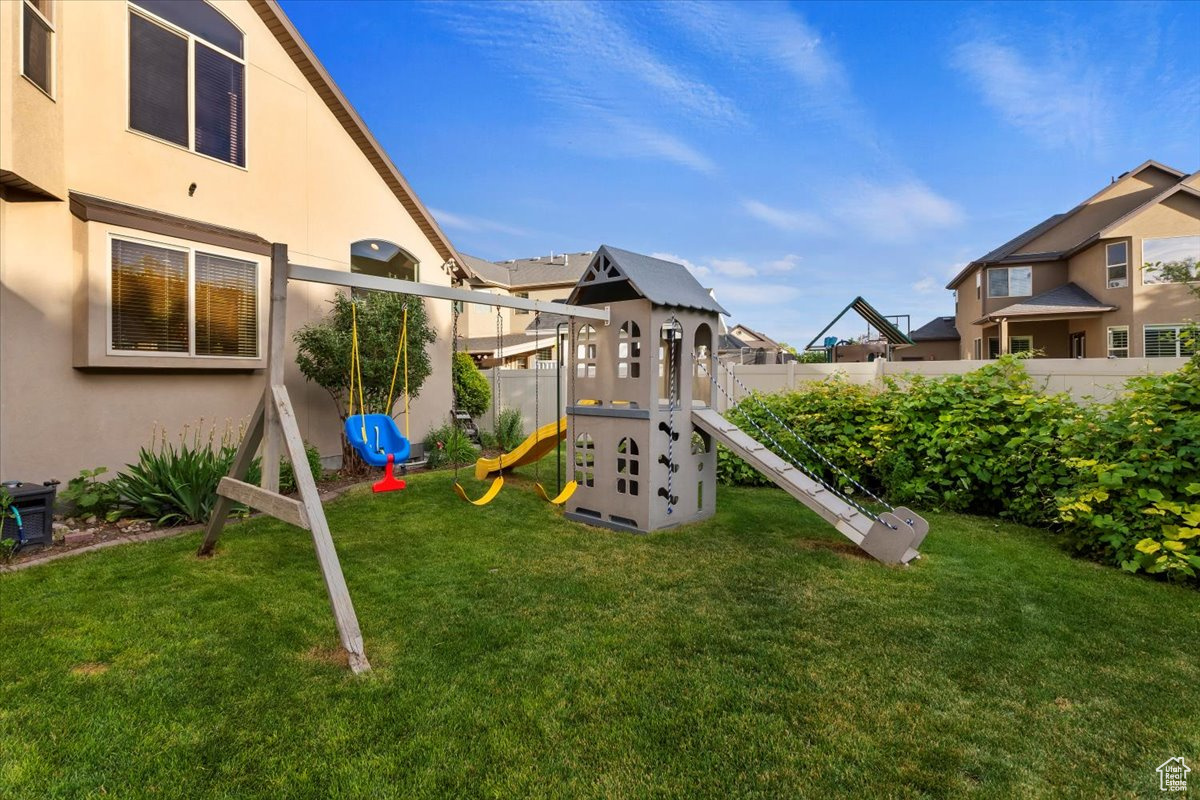 View of playground with a lawn