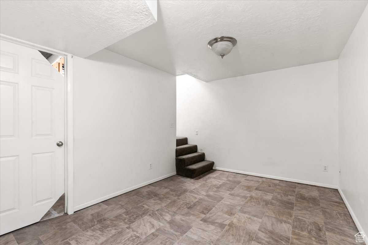 Basement with a textured ceiling