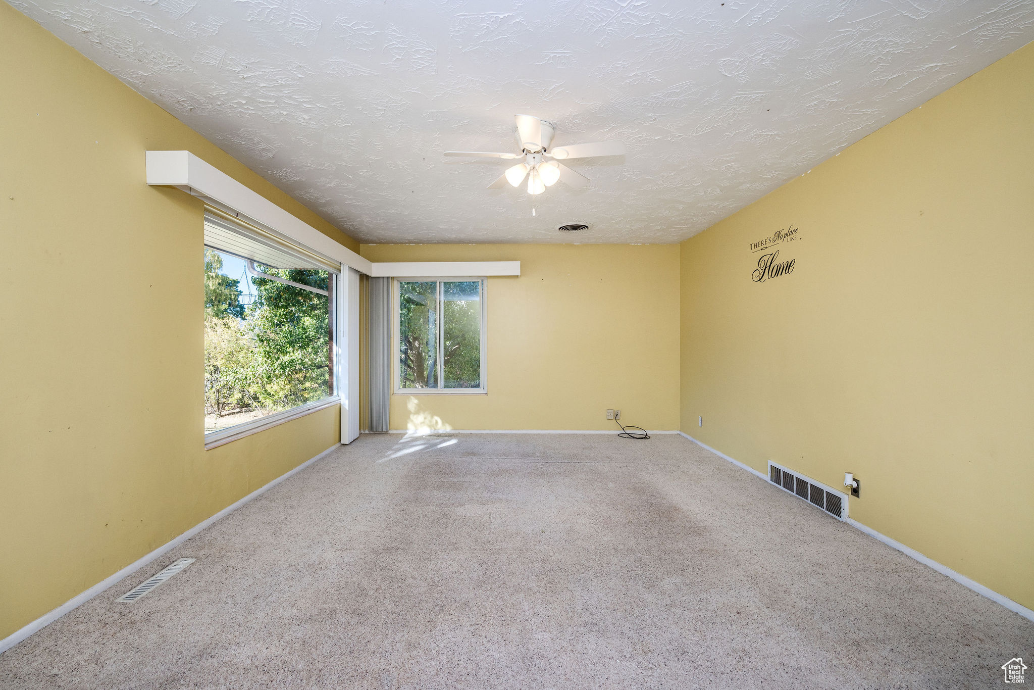 Living room with carpeted floors and lots of natural light