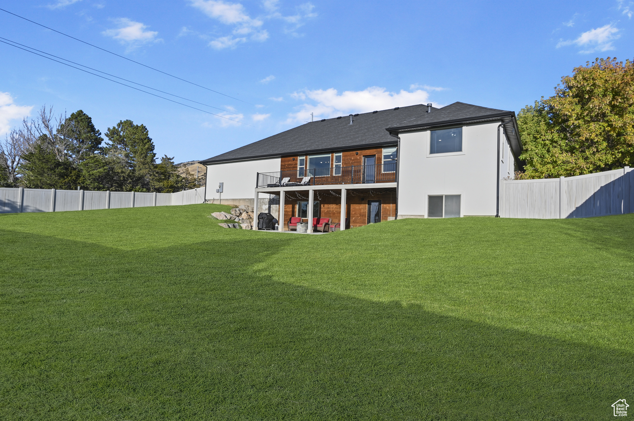 Back of house featuring a patio and a lawn