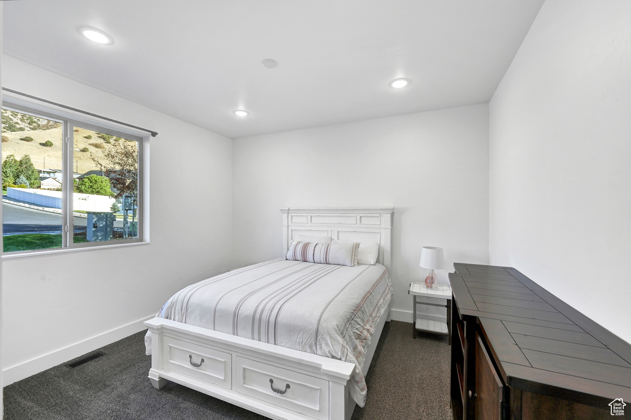 Bedroom with dark colored carpet