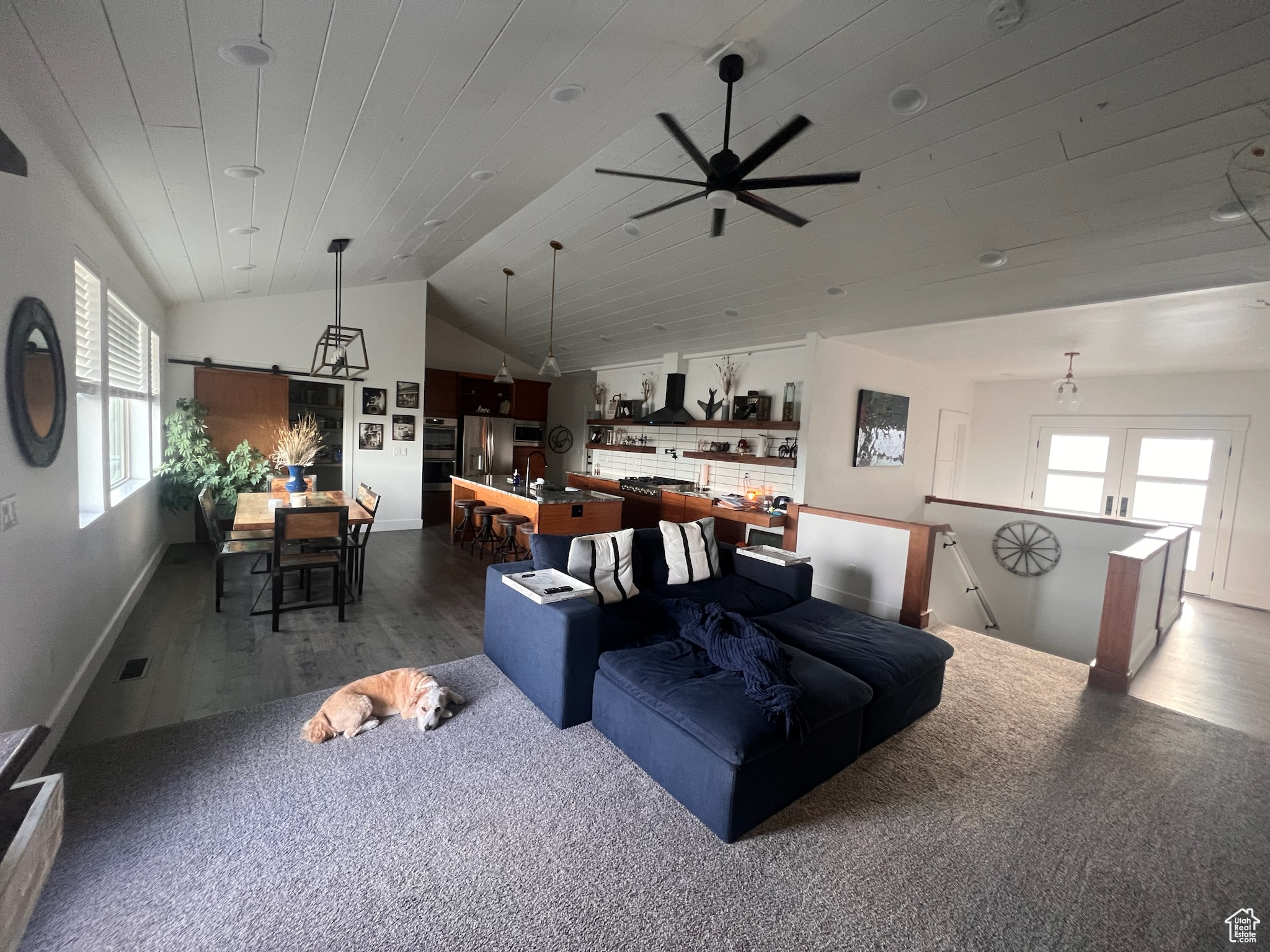 Living room with ceiling fan, lofted ceiling, dark hardwood / wood-style floors, and wood ceiling