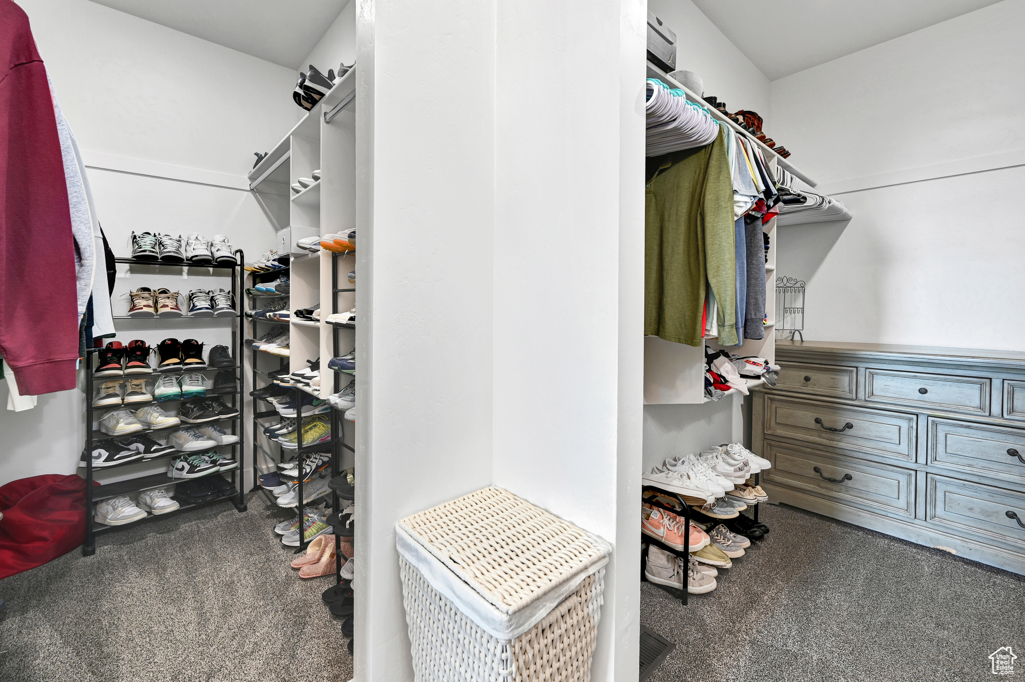 Walk in closet featuring dark colored carpet