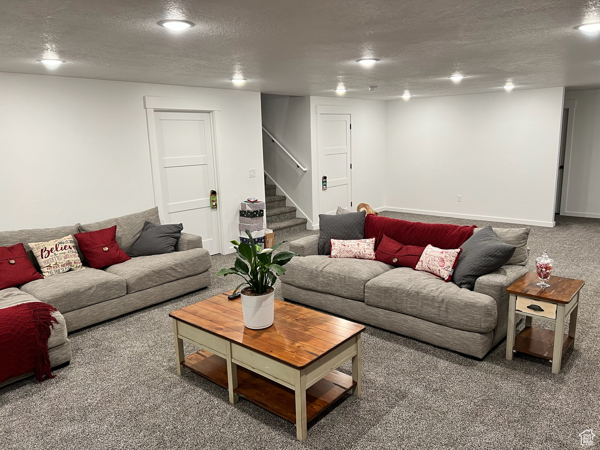 Living room with carpet and a textured ceiling