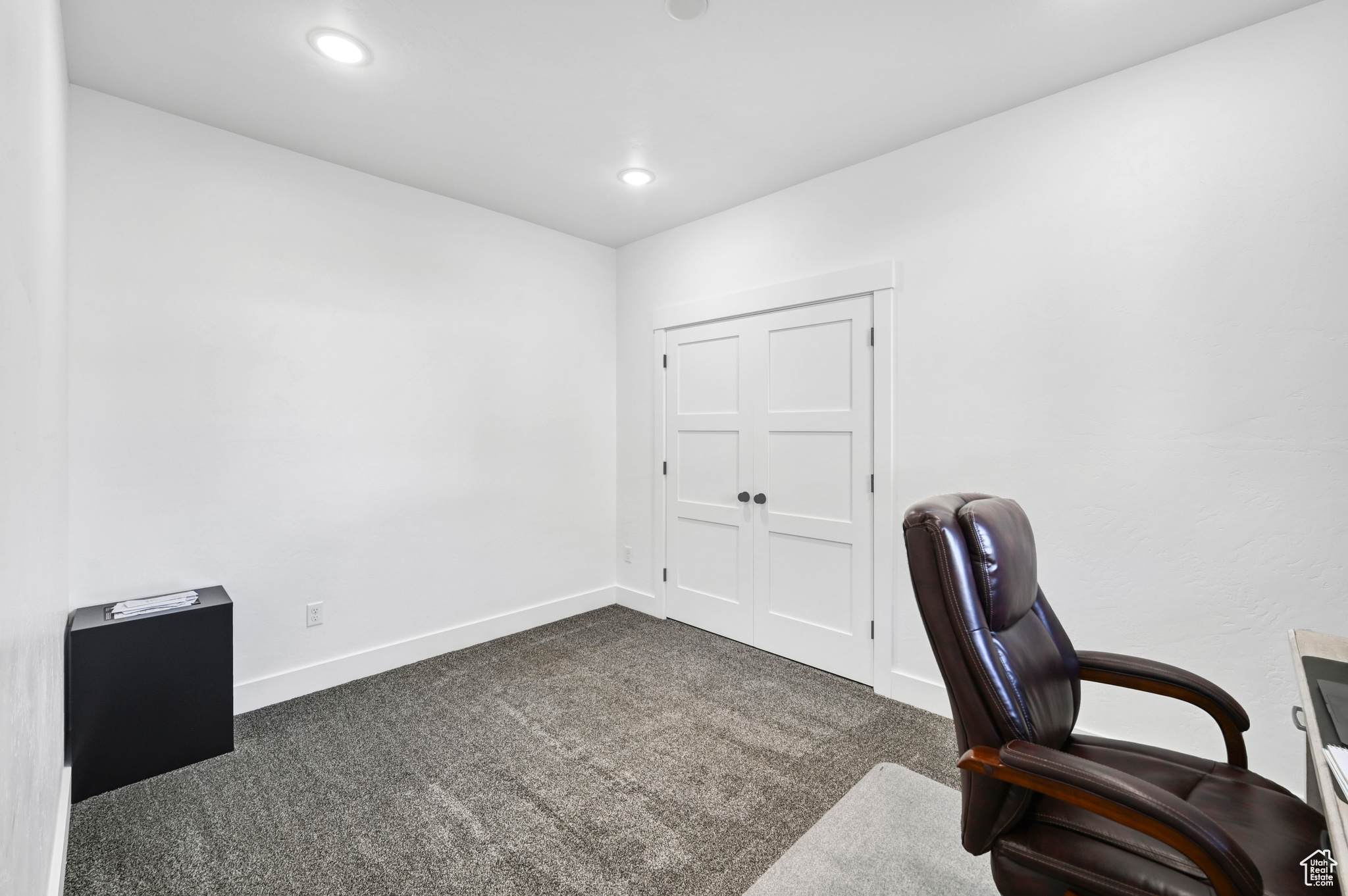 Office area featuring dark colored carpet