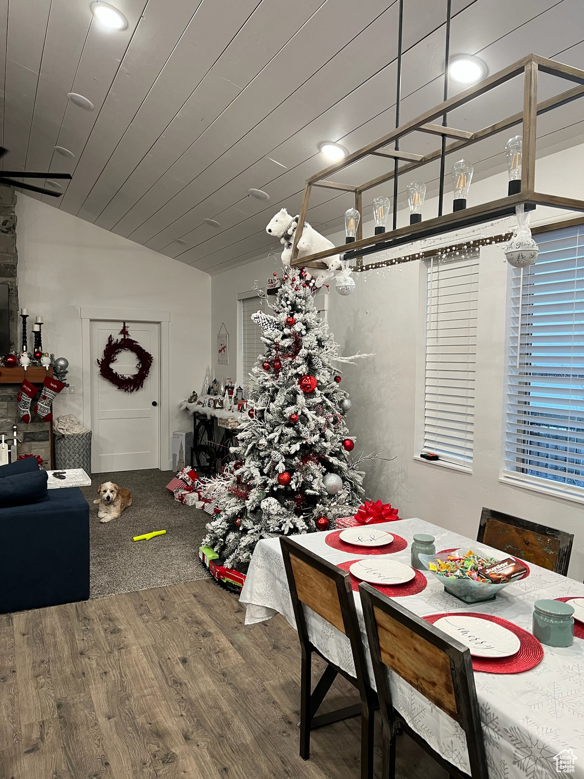 Dining space featuring wood-type flooring and vaulted ceiling