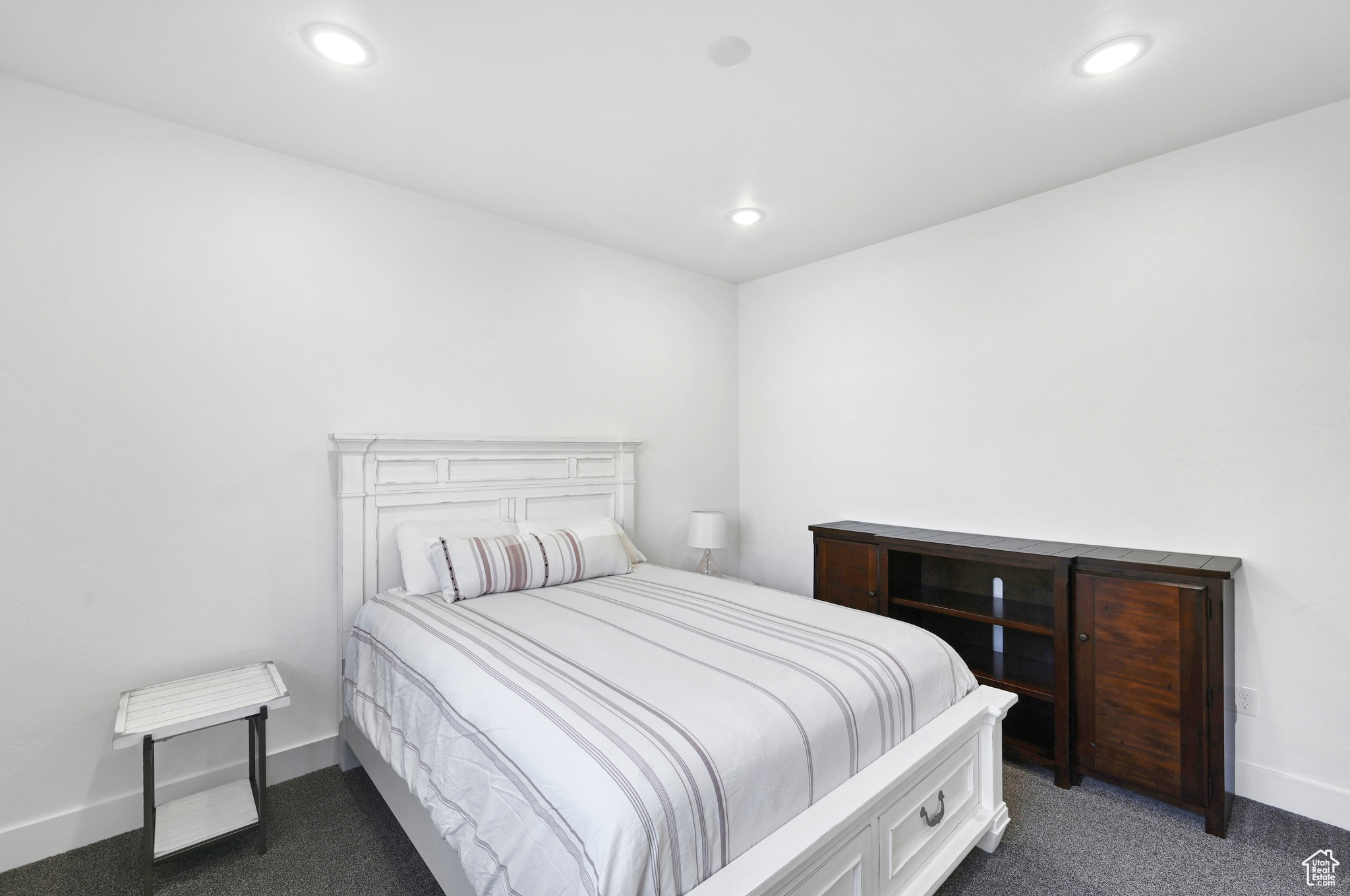 Bedroom featuring dark colored carpet