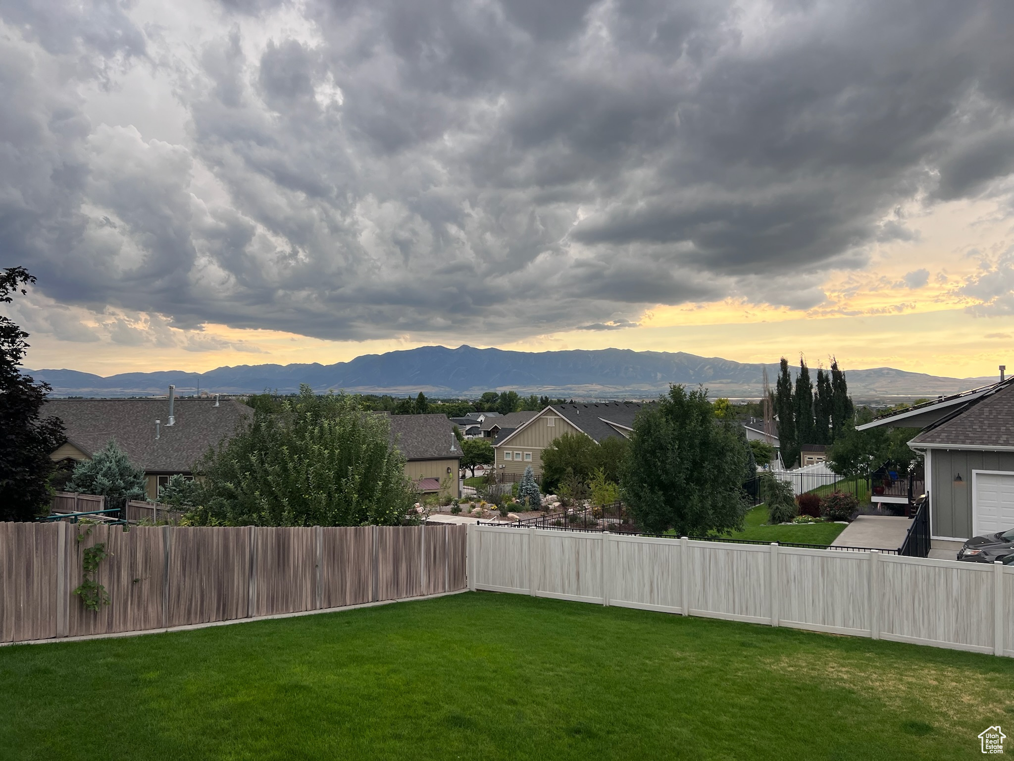 Yard at dusk featuring a mountain view