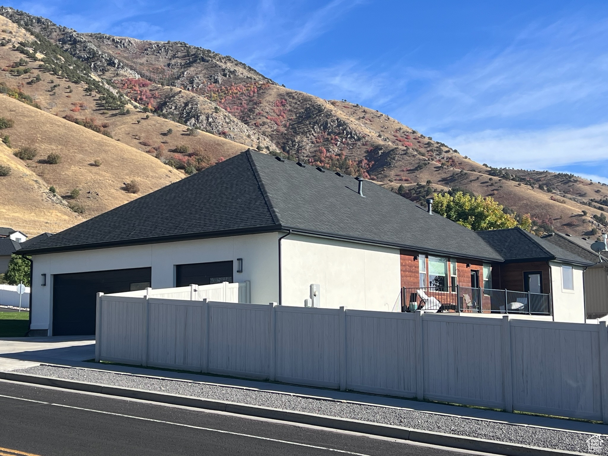 View of side of home featuring a mountain view and a garage