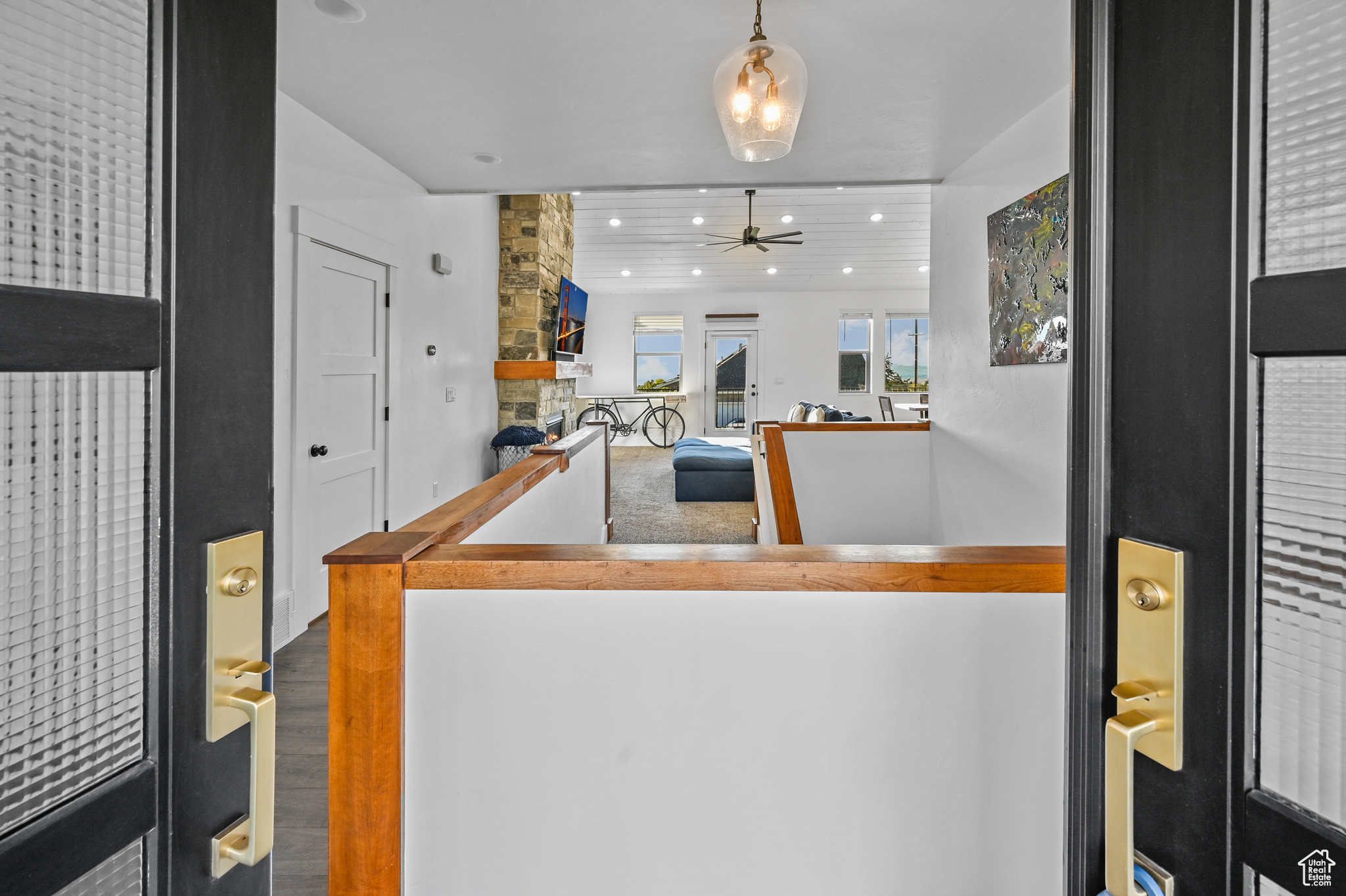 Kitchen with hardwood / wood-style flooring, ceiling fan, and hanging light fixtures