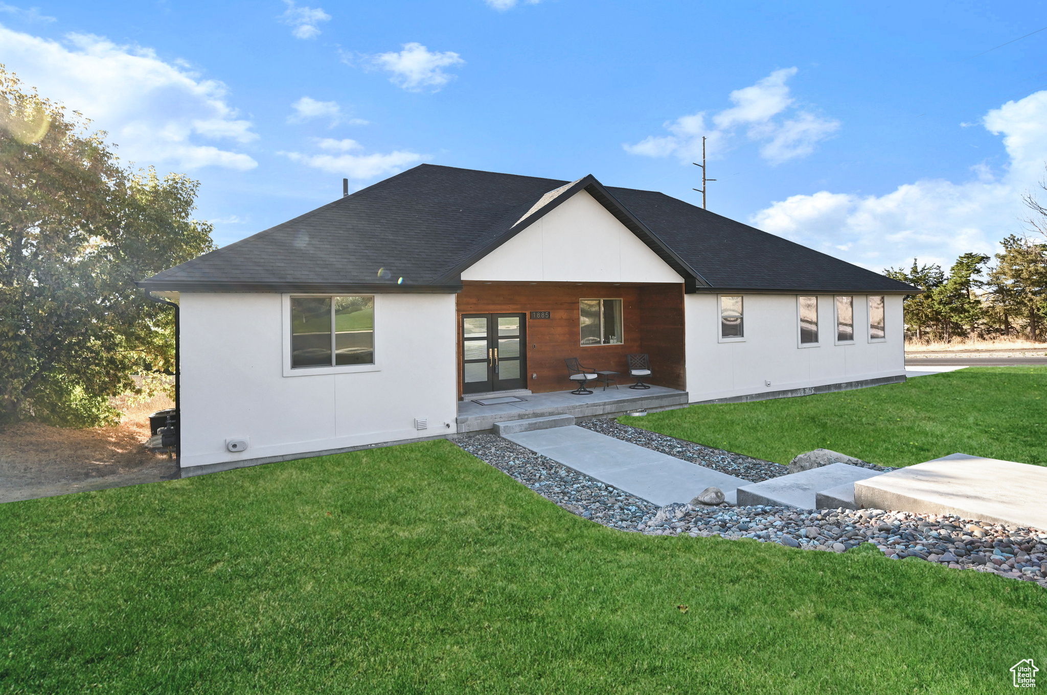 Back of property with a patio and a lawn