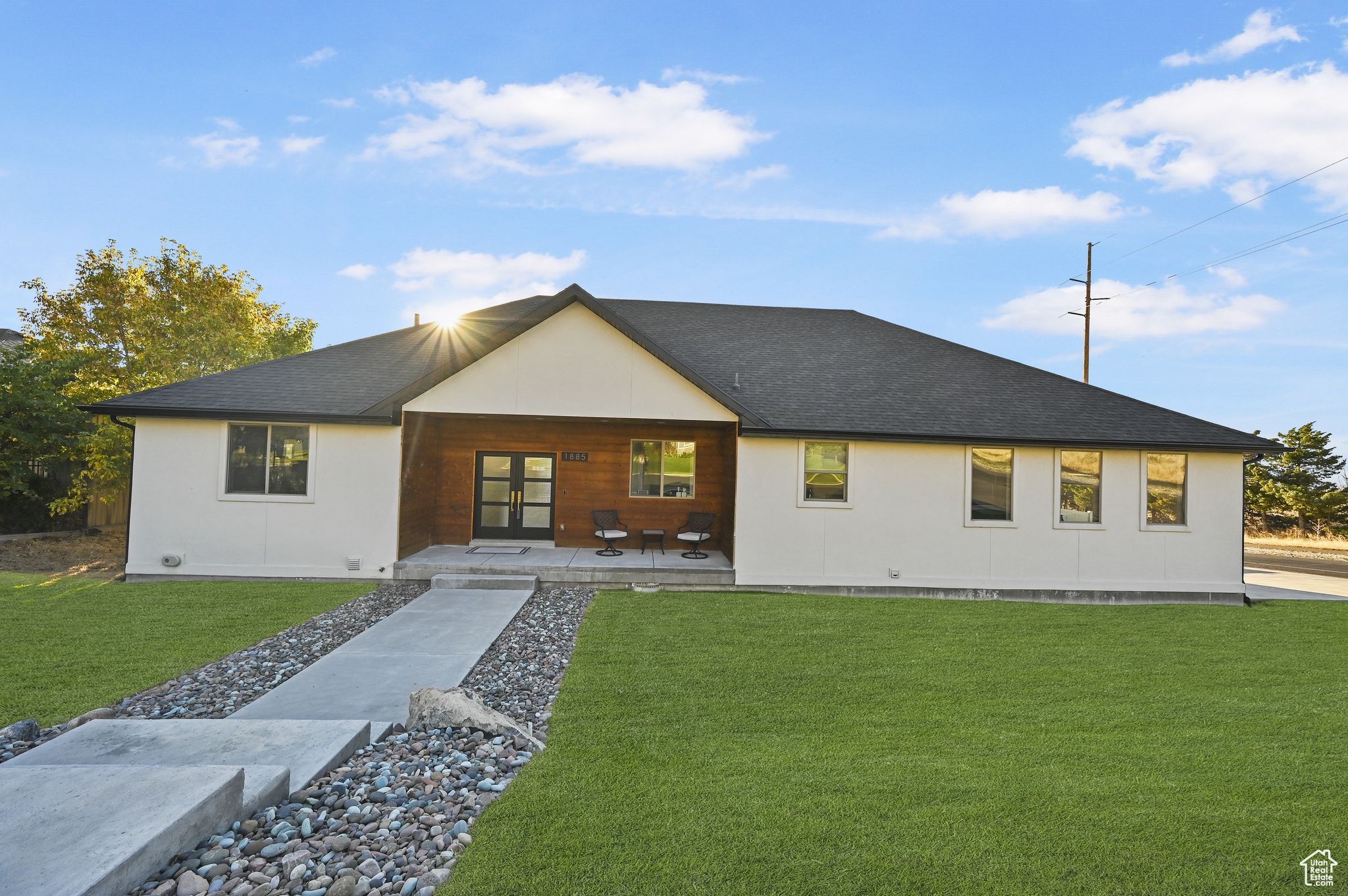 View of front facade featuring a front lawn and a patio