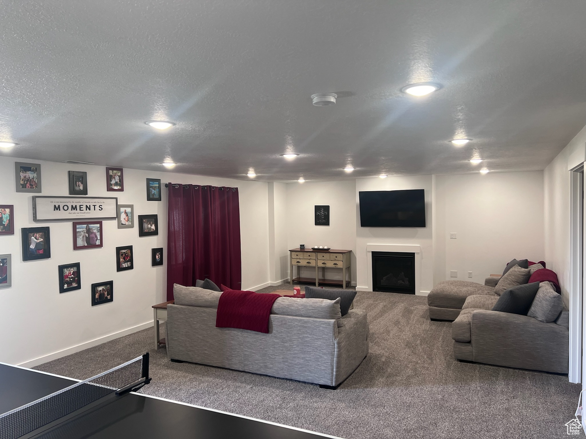 Living room with a textured ceiling and carpet