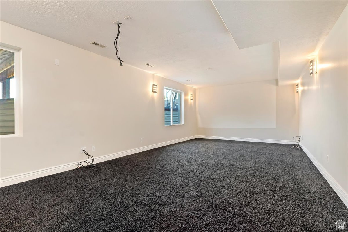 Spare room with a textured ceiling and carpet flooring