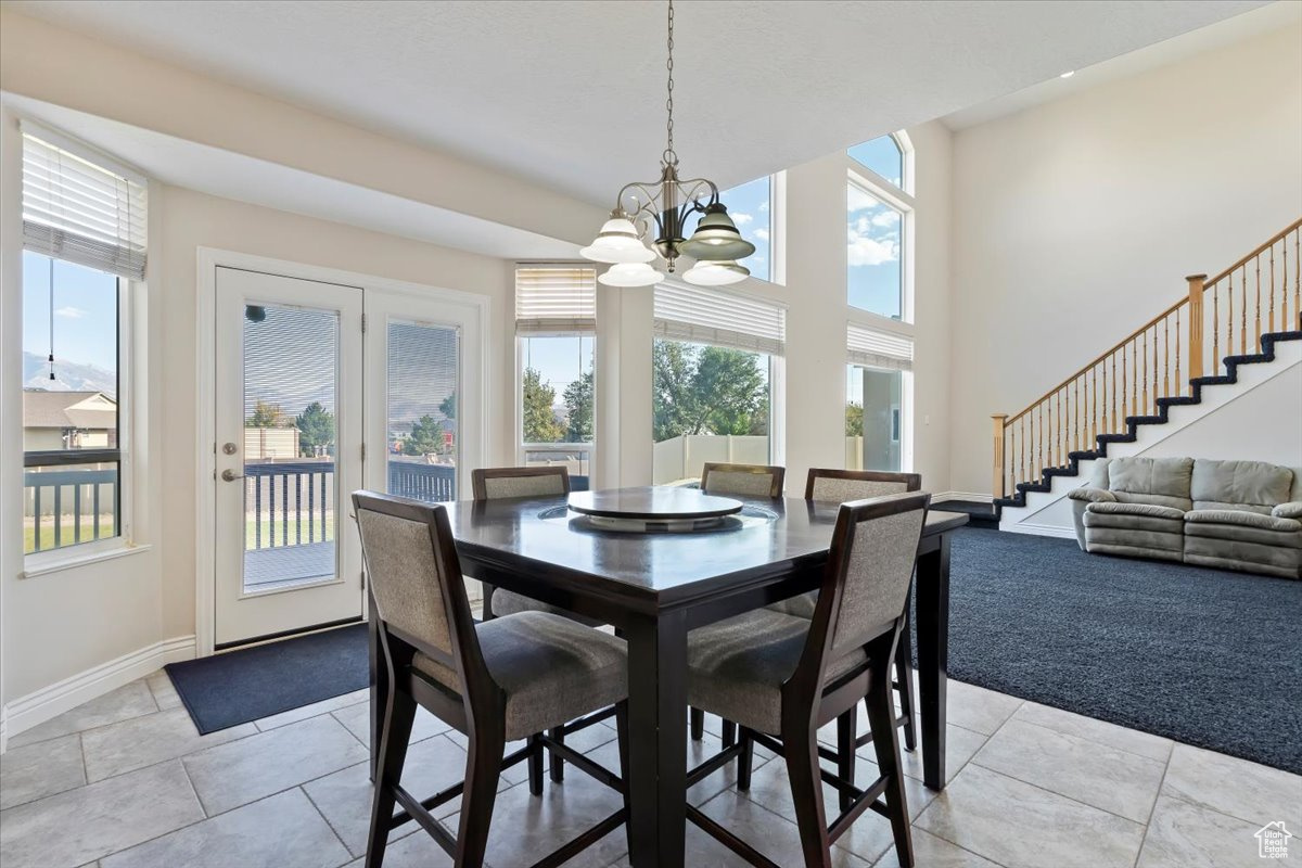 Dining area featuring light colored carpet and a chandelier