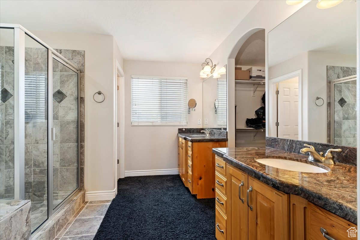 Bathroom featuring vanity and a shower with shower door