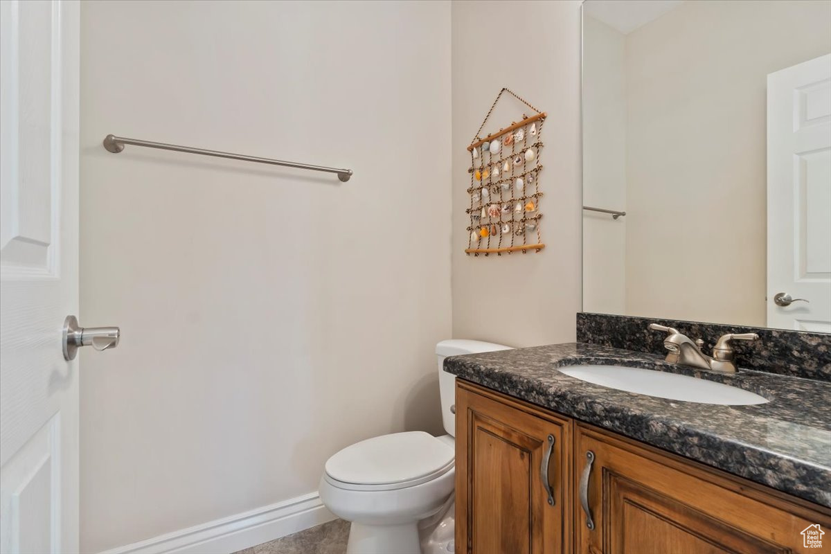 Bathroom with tile patterned flooring, vanity, and toilet