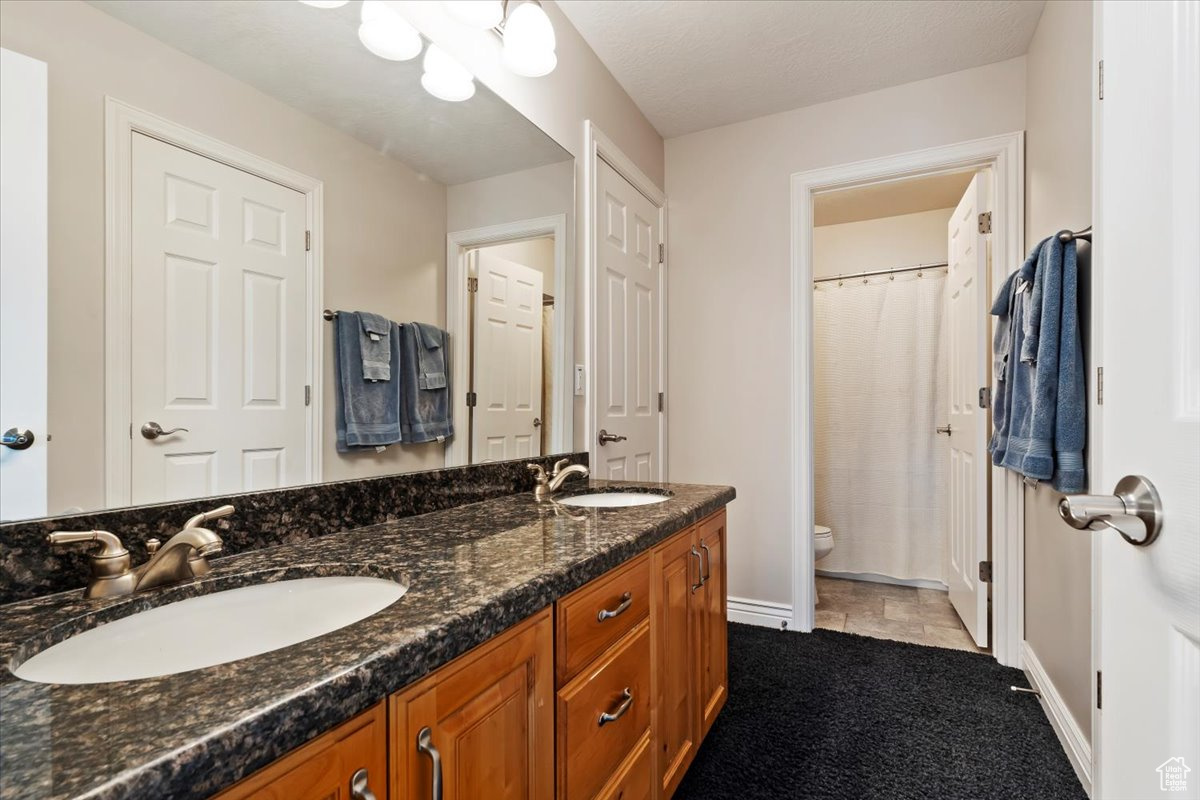 Bathroom featuring vanity and toilet