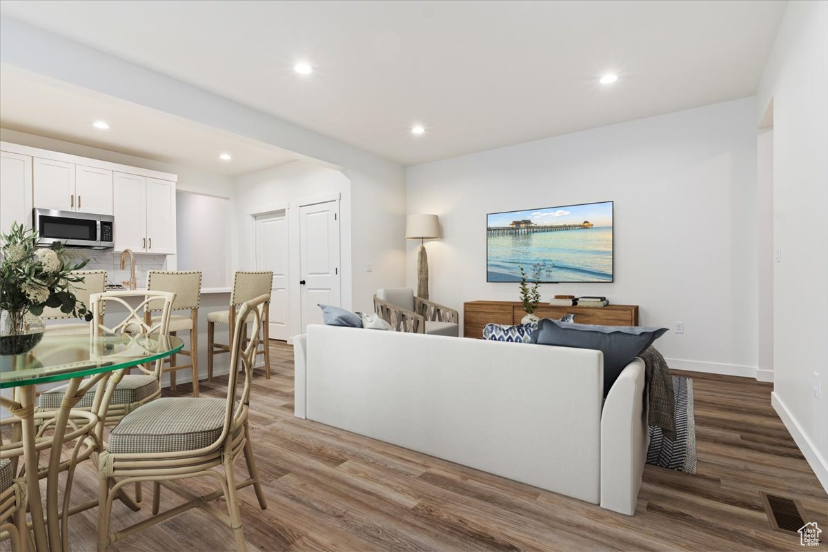 Living room with hardwood / wood-style flooring