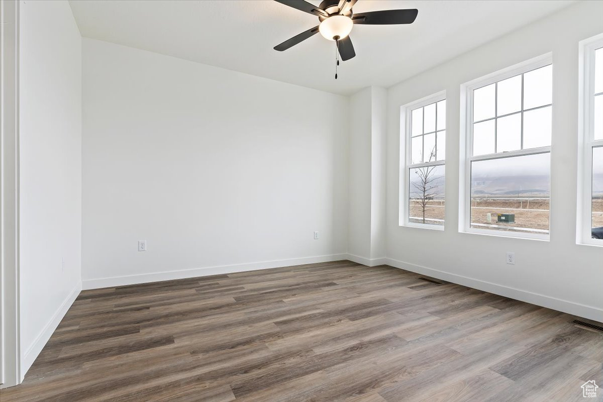 Spare room featuring ceiling fan and wood-type flooring