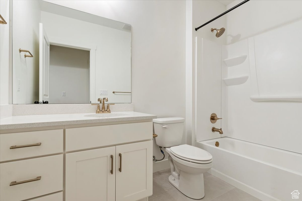 Full bathroom featuring tile patterned flooring, shower / bathing tub combination, vanity, and toilet