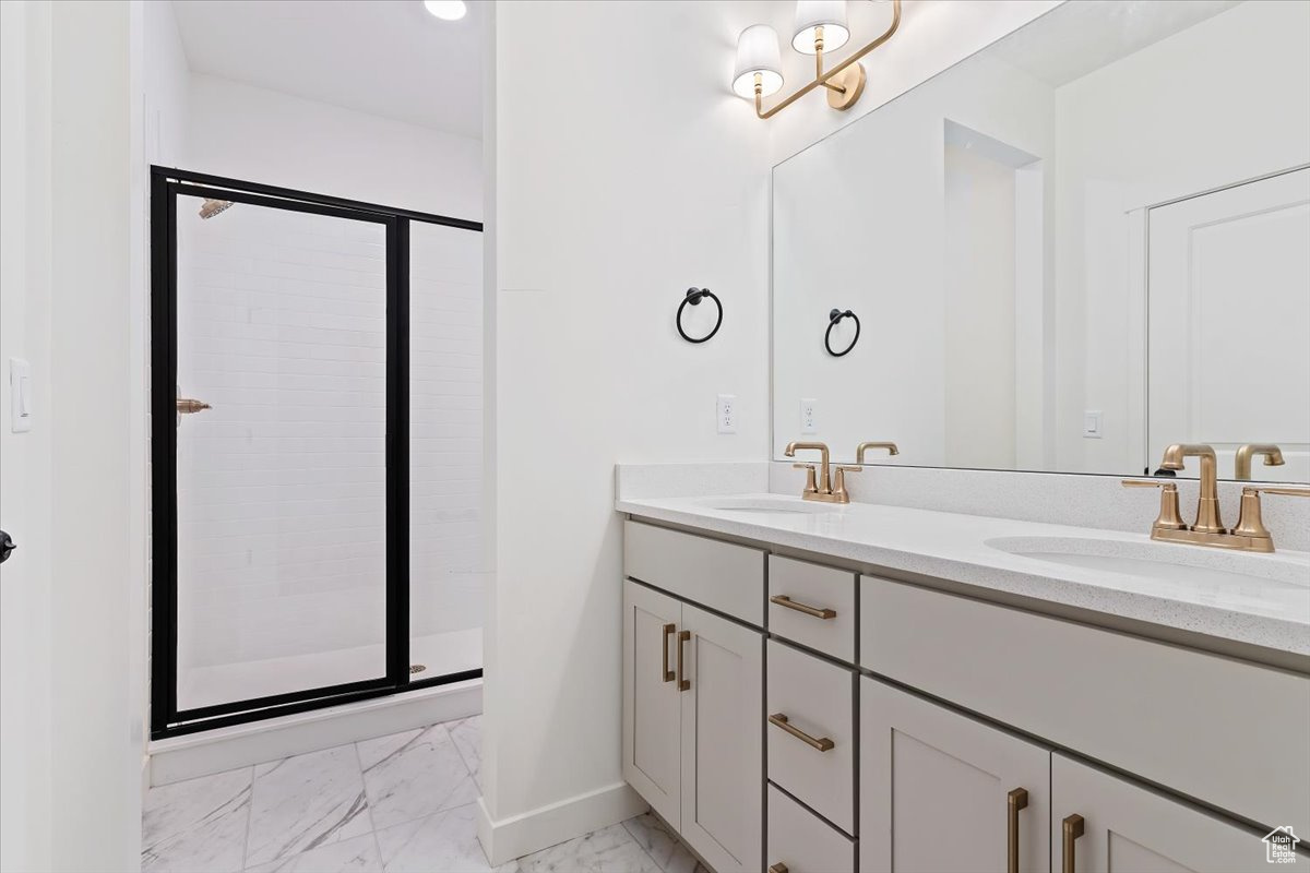 Bathroom with vanity and a shower with door