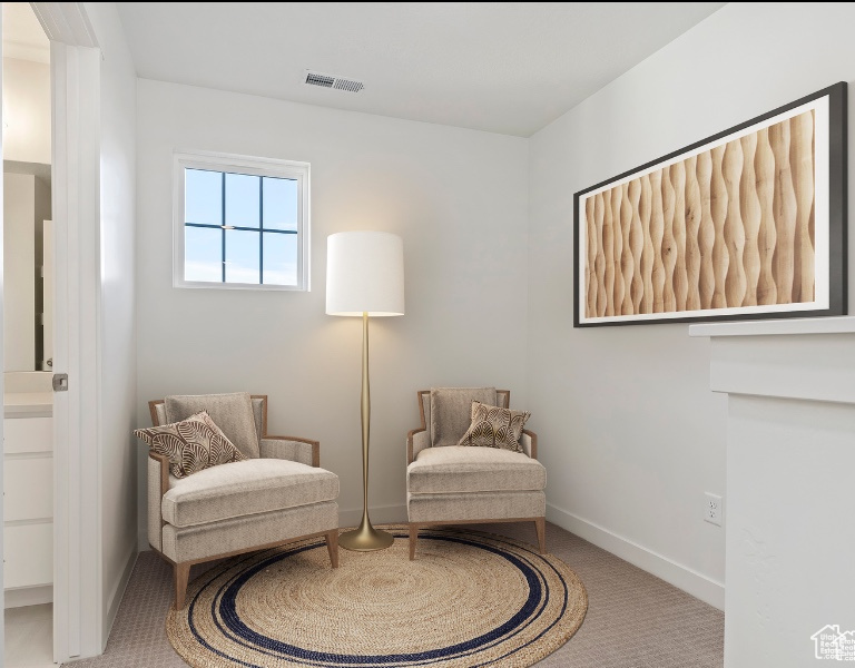 Living area featuring carpet flooring