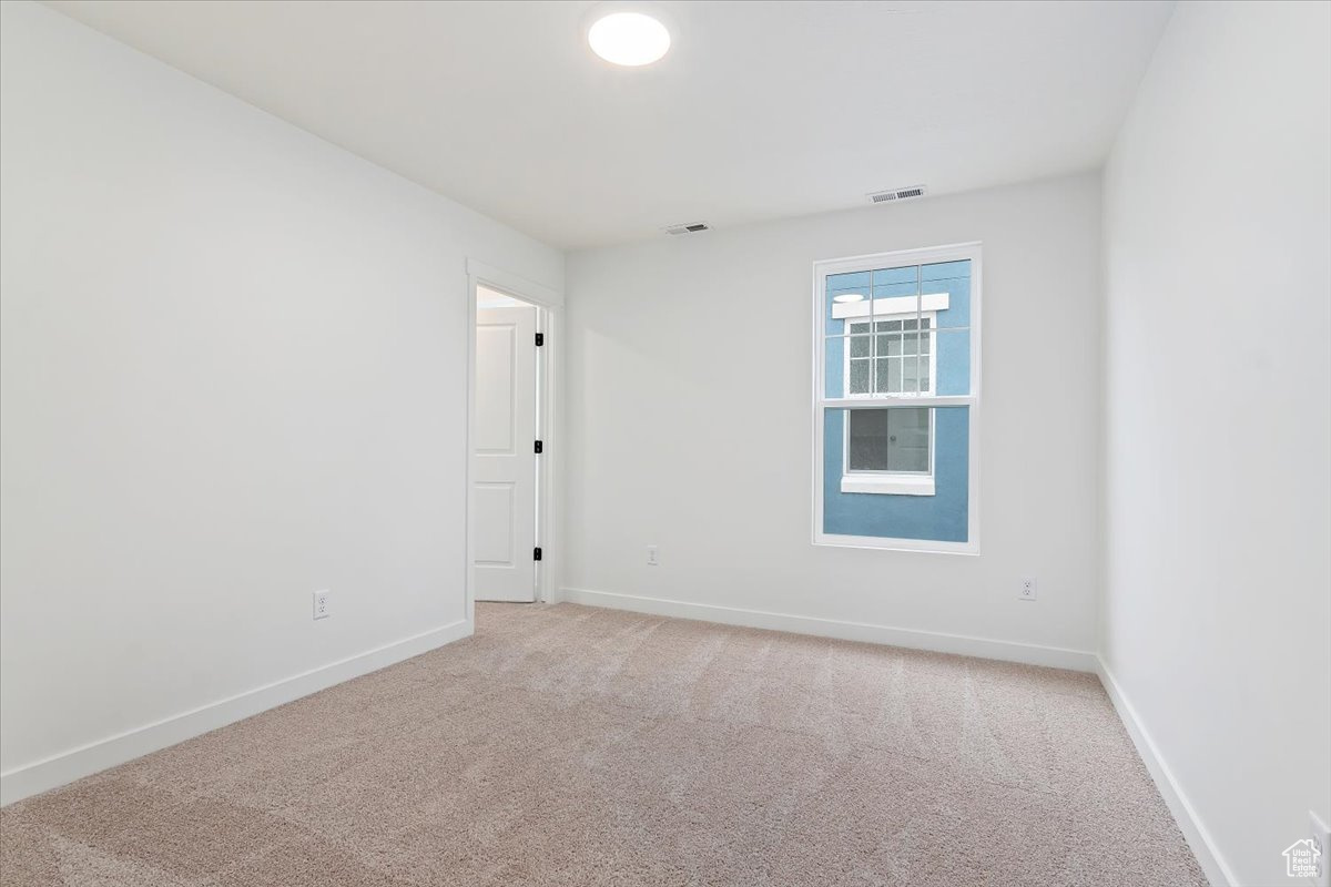 Spare room featuring carpet floors