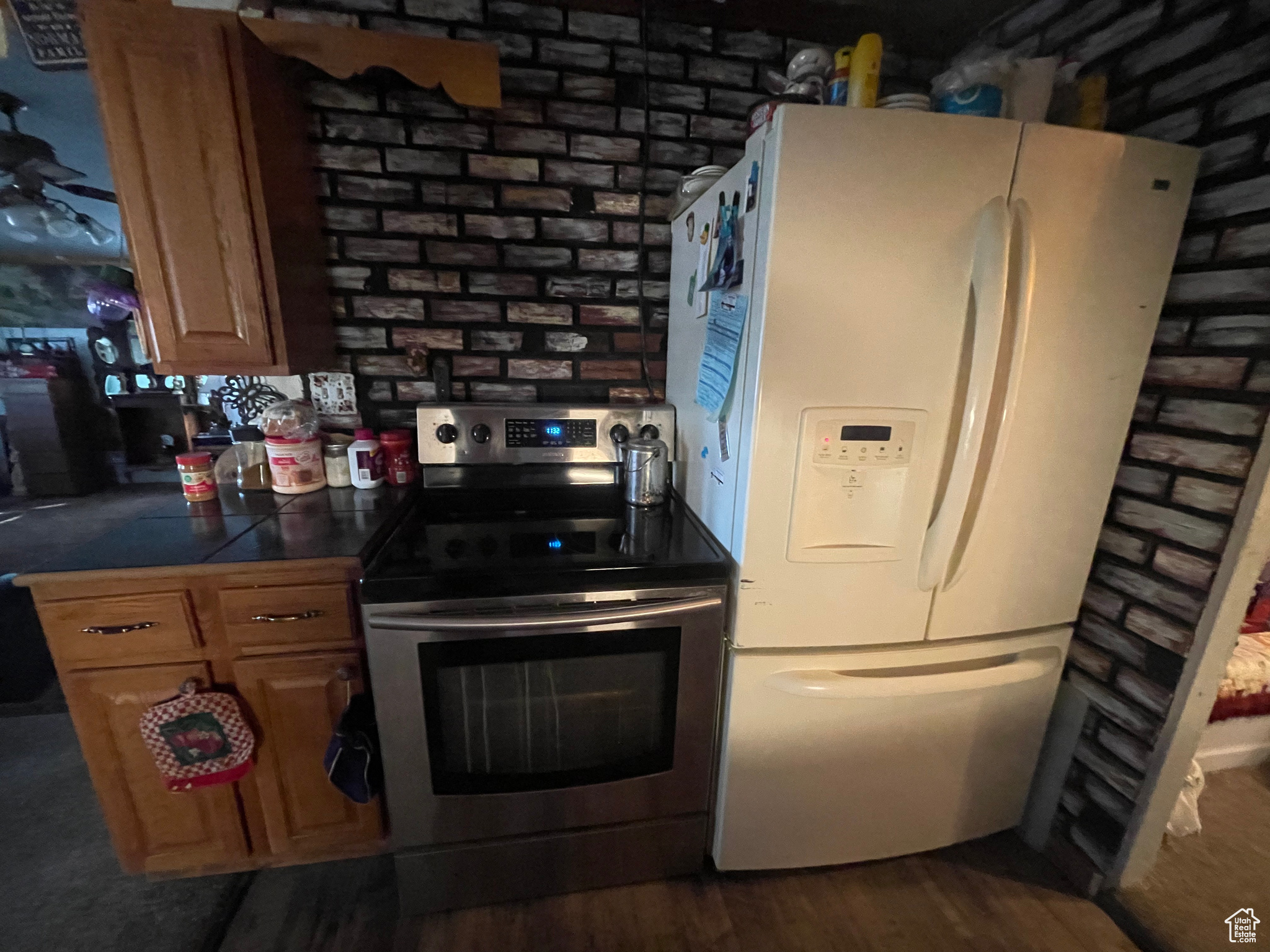 Kitchen featuring dark hardwood / wood-style floors, electric stove, and white refrigerator with ice dispenser